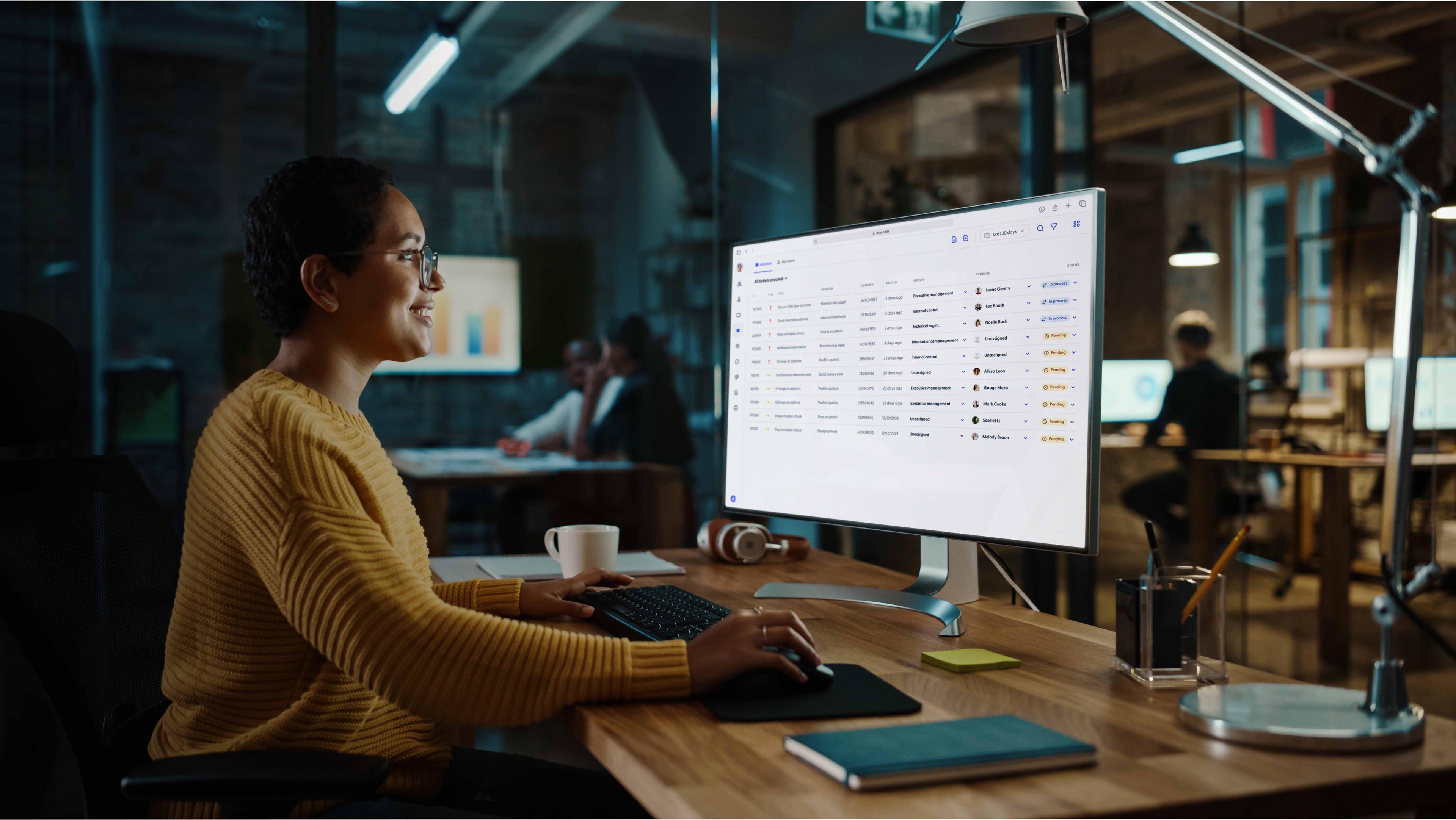 Woman smiling while looking at her computer